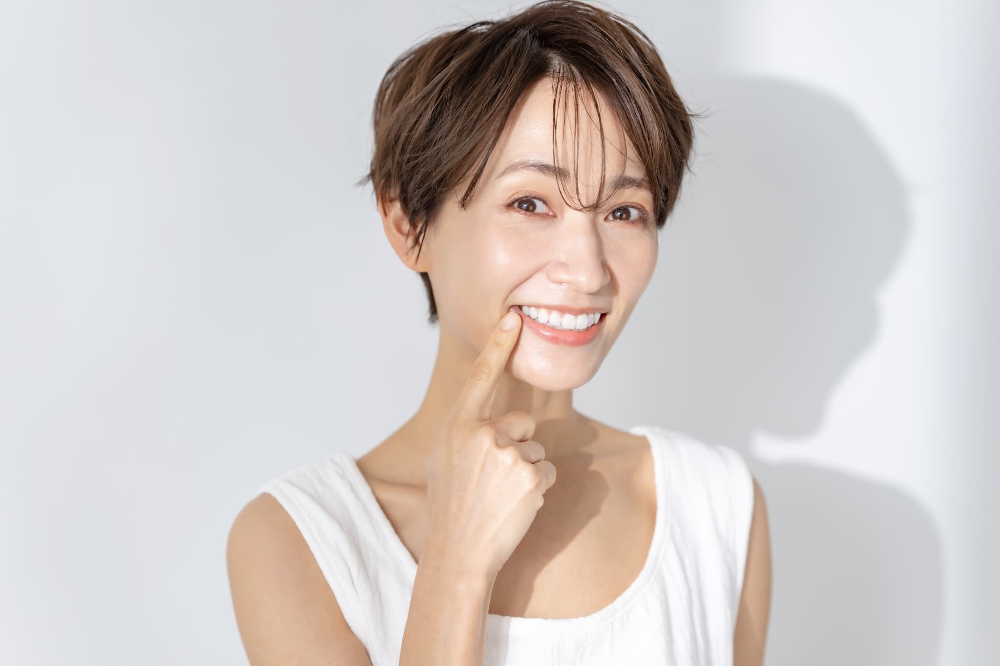 インプラント治療をして笑顔を見せる女性